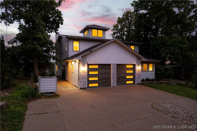 584 Black Hawk Dr, Lake Ozark, MO 65049 - contemporary house featuring concrete driveway, a garage, and board and batten siding