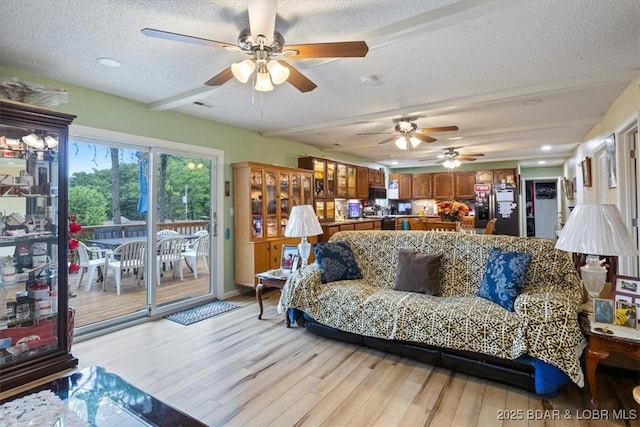 169 Kaanapali Dr, Roach, MO 65787 - living area with ceiling fan, a textured ceiling, and light wood-style floors