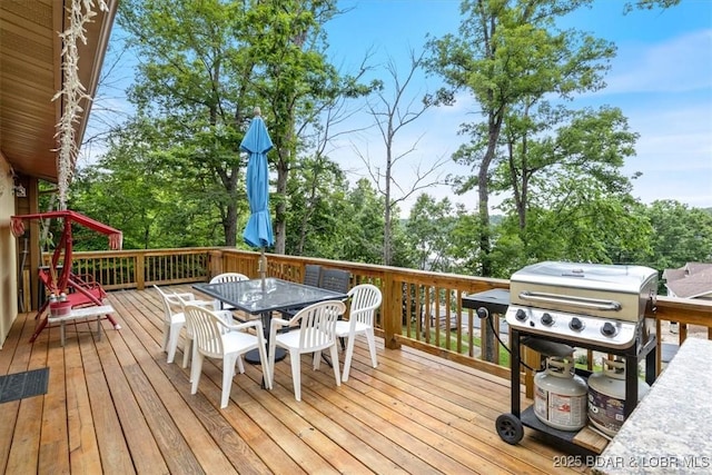 169 Kaanapali Dr, Roach, MO 65787 - wooden deck featuring a grill, outdoor dining area, and view of scattered trees