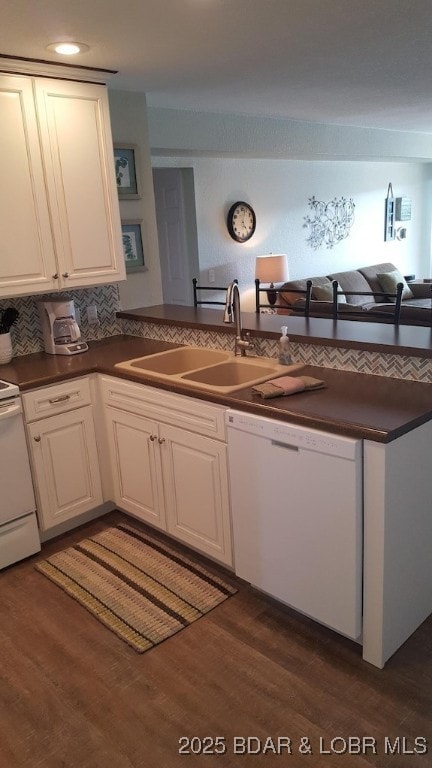 1481 Ledges Dr Unit 221, Osage Beach, MO 65065 - kitchen with white dishwasher, dark countertops, a sink, dark wood-style flooring, and range
