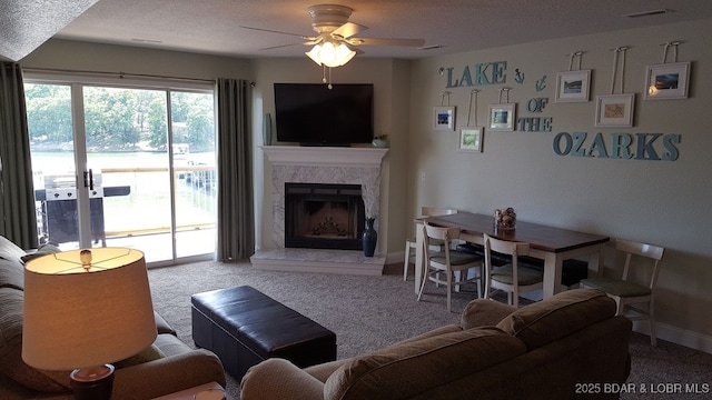 1481 Ledges Dr Unit 221, Osage Beach, MO 65065 - living area with ceiling fan, carpet, a textured ceiling, baseboards, and a high end fireplace