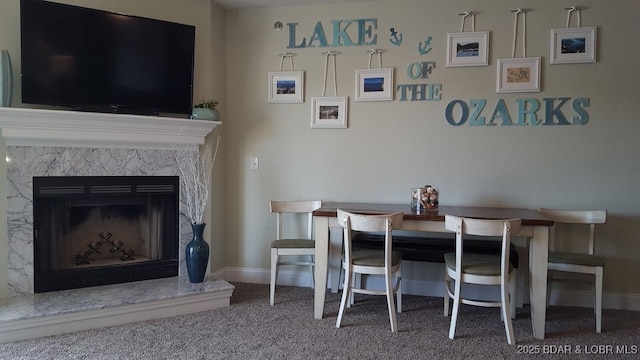 1481 Ledges Dr Unit 221, Osage Beach, MO 65065 - carpeted dining room with baseboards and a fireplace