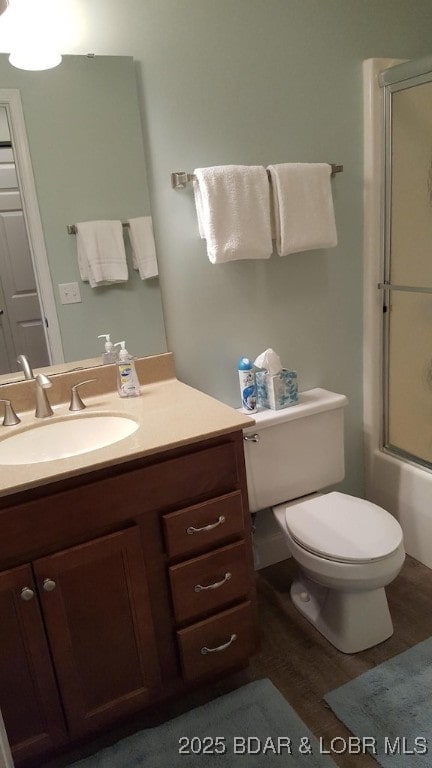 1481 Ledges Dr Unit 221, Osage Beach, MO 65065 - full bath with vanity, wood finished floors, toilet, and shower / bath combination with glass door