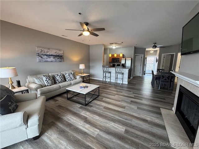 275 Flynn Rd Unit 207, Lake Ozark, MO 65049 - living room featuring a ceiling fan and dark wood-style flooring