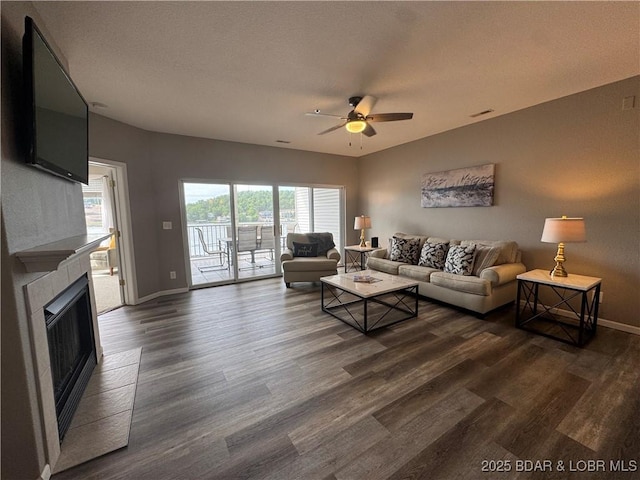 275 Flynn Rd Unit 207, Lake Ozark, MO 65049 - living area with ceiling fan, dark wood-style floors, and a tile fireplace