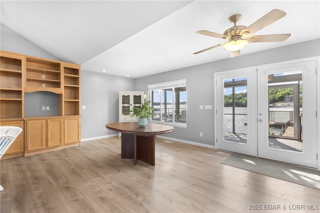 25 Redwood Ct, Sunrise Beach, MO 65079 - unfurnished dining area featuring french doors, light wood-type flooring, baseboards, ceiling fan, and lofted ceiling