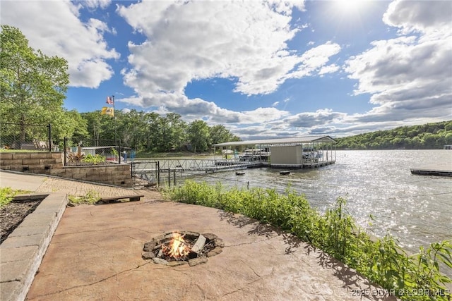 25 Redwood Ct, Sunrise Beach, MO 65079 - view of patio featuring an outdoor fire pit, a floating dock, and a water view