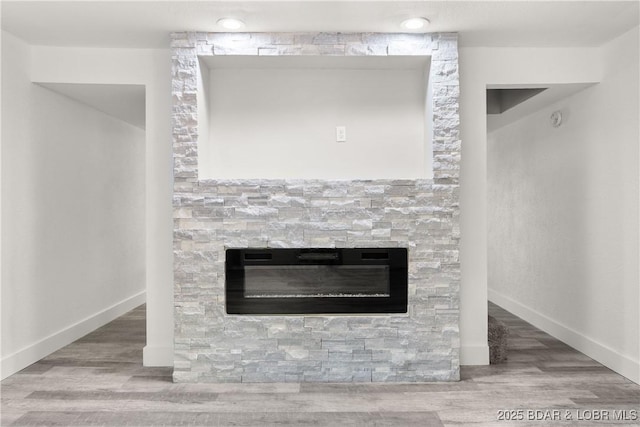 1318 Evergreen Ln Unit 4, Osage Beach, MO 65065 - detailed view of a stone fireplace, wood finished floors, and baseboards