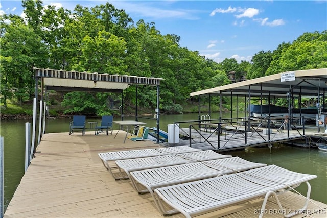 1318 Evergreen Ln Unit 4, Osage Beach, MO 65065 - dock with a water view, view of scattered trees, and boat lift