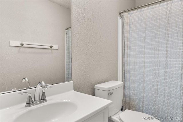 1318 Evergreen Ln Unit 4, Osage Beach, MO 65065 - bathroom with toilet, a textured wall, vanity, and curtained shower