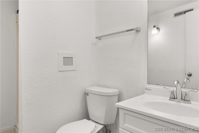 1318 Evergreen Ln Unit 4, Osage Beach, MO 65065 - bathroom with vanity, toilet, and a textured wall