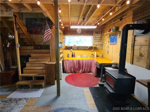 31025 Broken Circle Rd, Stover, MO 65078 - basement featuring a wood stove and stairs