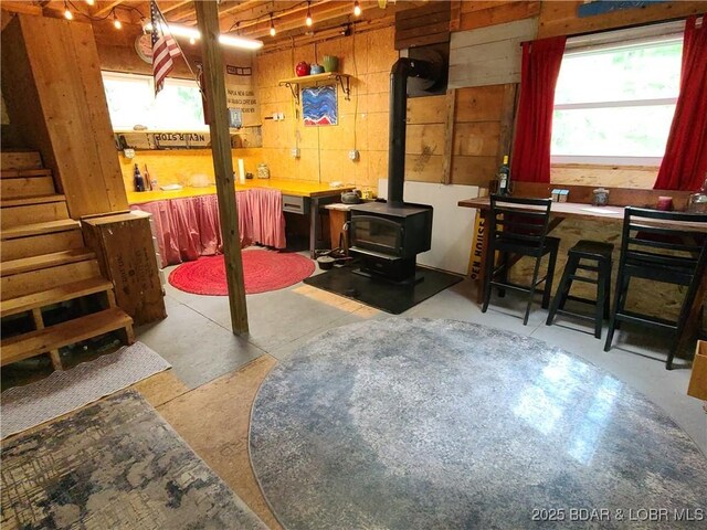 31025 Broken Circle Rd, Stover, MO 65078 - basement featuring a wood stove and wooden walls
