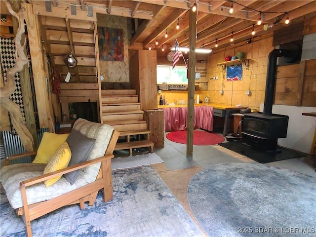 31025 Broken Circle Rd, Stover, MO 65078 - living room featuring concrete floors, a wood stove, and stairs