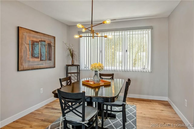 701 Cedar Rd Unit 1A, Lake Ozark, MO 65049 - dining area featuring wood finished floors, baseboards, and a chandelier
