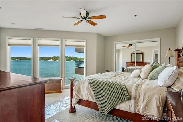 701 Cedar Rd Unit 1A, Lake Ozark, MO 65049 - bedroom with multiple windows, light carpet, a water view, and ceiling fan
