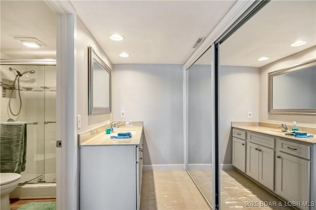 701 Cedar Rd Unit 1A, Lake Ozark, MO 65049 - bathroom featuring vanity, a shower stall, toilet, baseboards, and recessed lighting