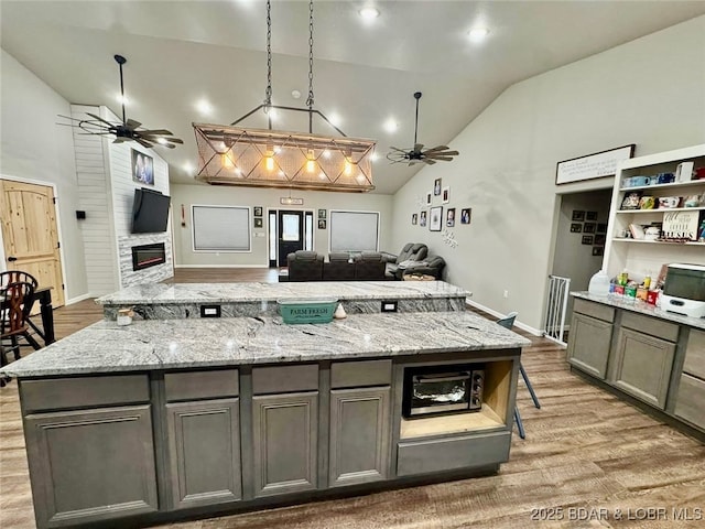 1760 Deans Creek Rd, Richland, MO 65556 - kitchen with a ceiling fan, open floor plan, lofted ceiling, and open shelves