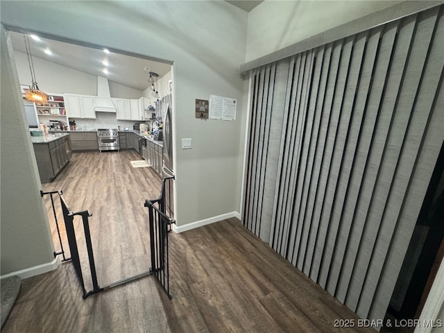 1760 Deans Creek Rd, Richland, MO 65556 - hallway featuring wood finished floors, vaulted ceiling, an upstairs landing, and baseboards