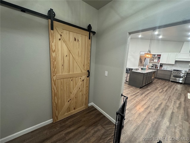 1760 Deans Creek Rd, Richland, MO 65556 - kitchen featuring high end stainless steel range oven, dark wood-type flooring, a barn door, light countertops, and baseboards
