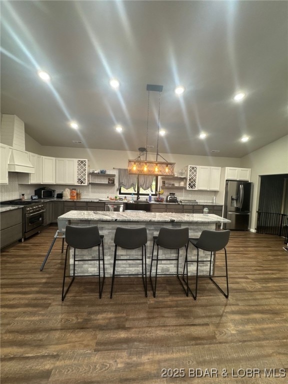 1760 Deans Creek Rd, Richland, MO 65556 - kitchen featuring stainless steel appliances, a kitchen bar, white cabinets, lofted ceiling, and tasteful backsplash