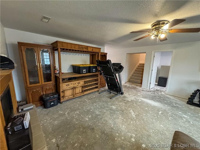 18400 Alum Springs Rd, Versailles, MO 65084 - living area featuring a ceiling fan, stairs, and a textured ceiling