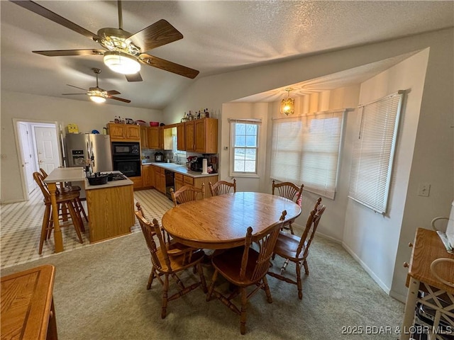 18400 Alum Springs Rd, Versailles, MO 65084 - dining area with light colored carpet, vaulted ceiling, baseboards, a ceiling fan, and a textured ceiling