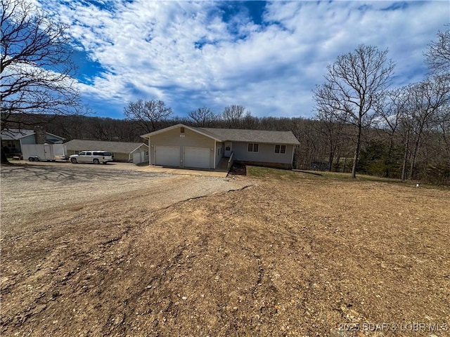 18400 Alum Springs Rd, Versailles, MO 65084 - ranch-style home with an attached garage and driveway