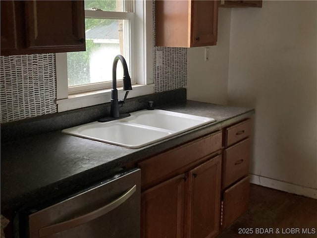 203 S Hunter St, Versailles, MO 65084 - kitchen with a sink, dishwasher, dark countertops, and tasteful backsplash