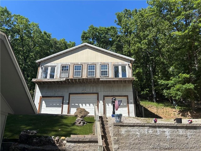 406 Staley Hollow Dr, Sunrise Beach, MO 65079 - view of front of house with a garage and driveway
