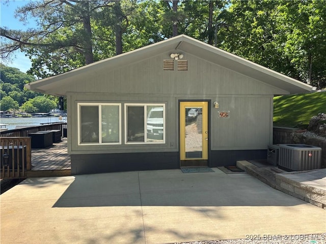 406 Staley Hollow Dr, Sunrise Beach, MO 65079 - view of front of property featuring central air condition unit, a wooden deck, and a patio