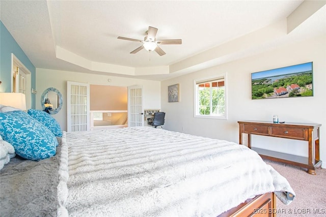 4066 Horseshoe Bend Pkwy Unit 3A, Lake Ozark, MO 65049 - bedroom with a tray ceiling, carpet floors, french doors, and ceiling fan