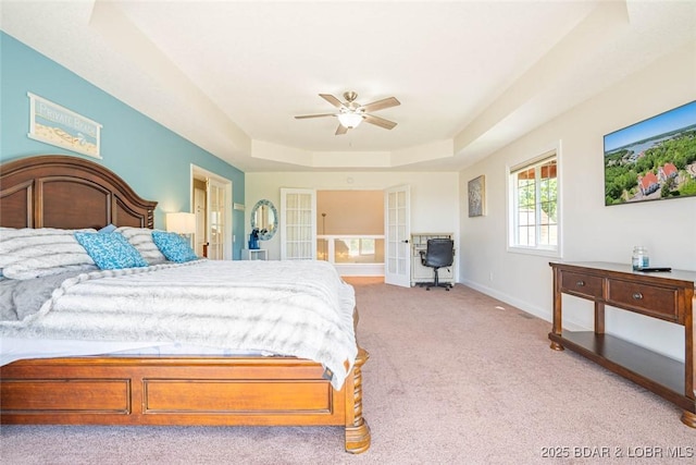 4066 Horseshoe Bend Pkwy Unit 3A, Lake Ozark, MO 65049 - bedroom with a raised ceiling, light colored carpet, baseboards, ensuite bath, and a ceiling fan