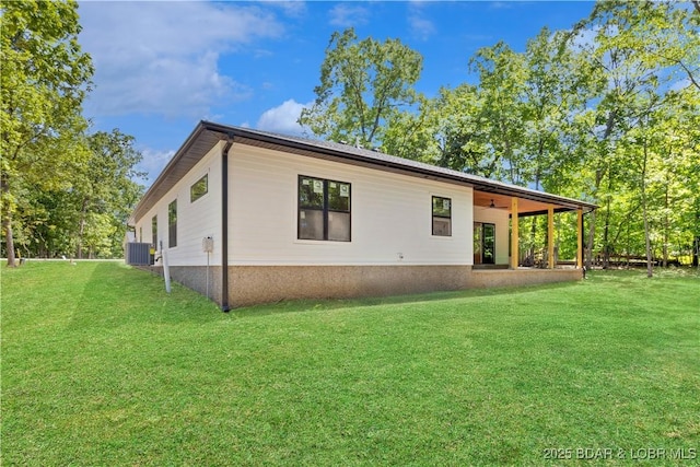 535 Grand Point Blvd, Sunrise Beach, MO 65079 - view of side of home with central air condition unit, a lawn, and ceiling fan