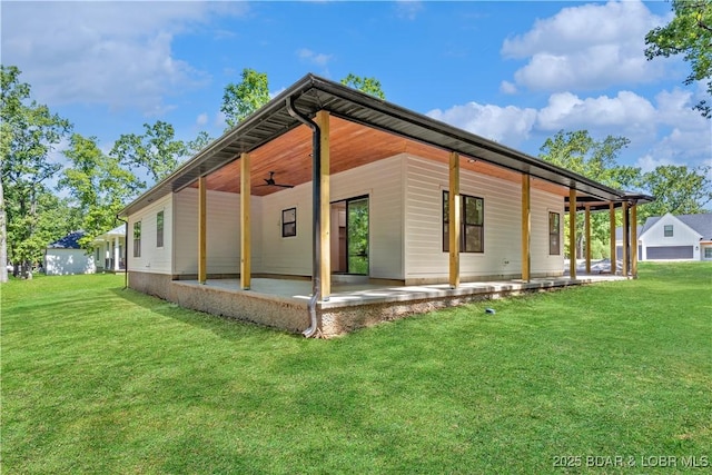 535 Grand Point Blvd, Sunrise Beach, MO 65079 - view of property exterior with a patio area, a yard, and a ceiling fan