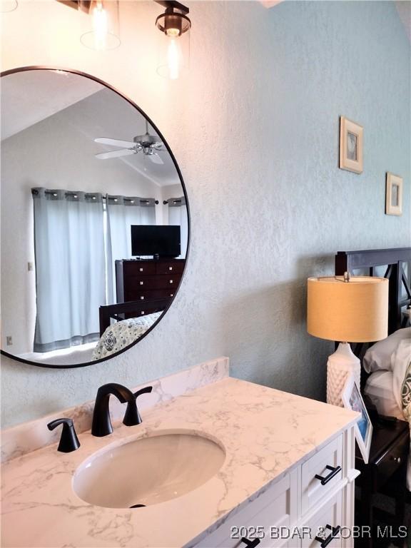 2500 Bay Point Ln Unit 342, Osage Beach, MO 65020 - bathroom featuring vanity, a ceiling fan, and a textured wall