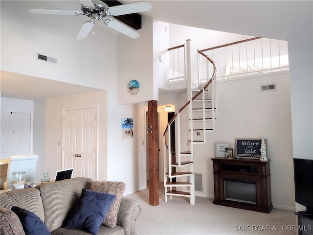 2500 Bay Point Ln Unit 342, Osage Beach, MO 65020 - living room with high vaulted ceiling, carpet flooring, a ceiling fan, and stairs