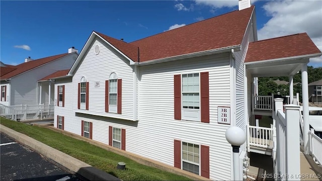 289 Charleston Dr Unit 2B, Lake Ozark, MO 65049 - view of home's exterior featuring roof with shingles
