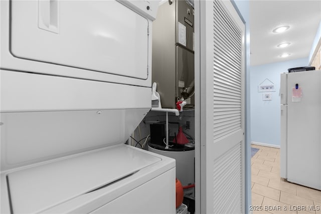 289 Charleston Dr Unit 2B, Lake Ozark, MO 65049 - laundry room featuring stacked washer / drying machine, light tile patterned floors, and recessed lighting