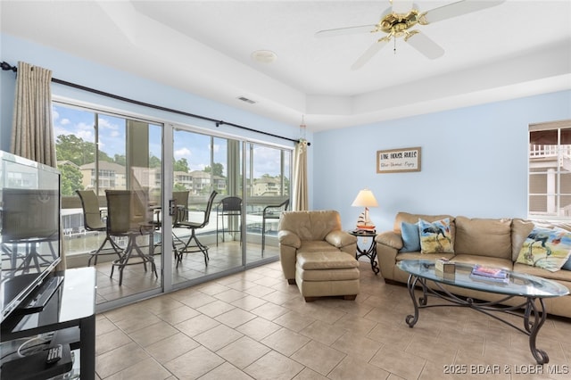 289 Charleston Dr Unit 2B, Lake Ozark, MO 65049 - living area with plenty of natural light, a ceiling fan, and a raised ceiling