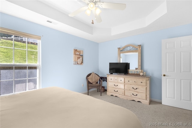 289 Charleston Dr Unit 2B, Lake Ozark, MO 65049 - carpeted bedroom with a tray ceiling, ceiling fan, and baseboards