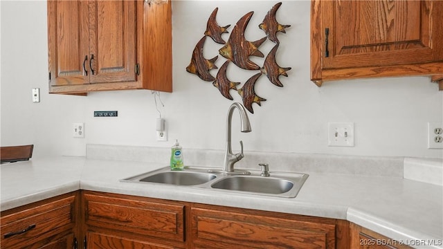 111 Rock Dove Ln Unit 3A, Camdenton, MO 65020 - kitchen with a sink, light countertops, and brown cabinetry
