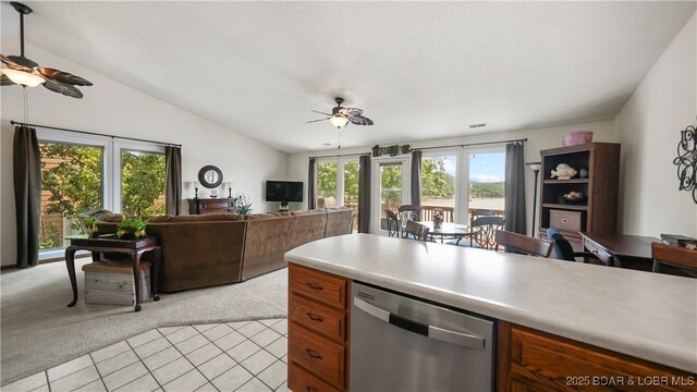111 Rock Dove Ln Unit 3A, Camdenton, MO 65020 - kitchen featuring a ceiling fan, stainless steel dishwasher, light carpet, healthy amount of natural light, and lofted ceiling