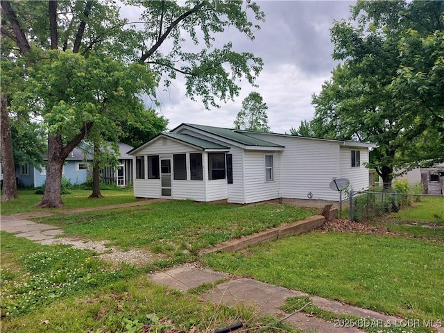 203 3rd St, Stover, MO 65078 - ranch-style house with a front yard and a sunroom