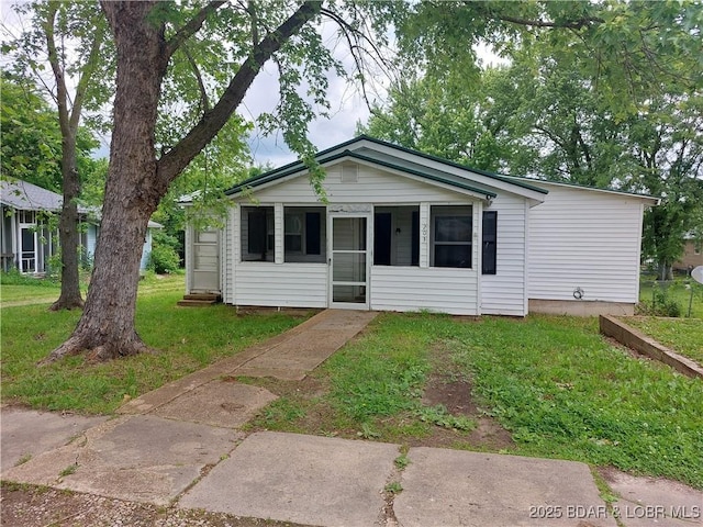 203 3rd St, Stover, MO 65078 - view of front facade featuring a front yard and a sunroom