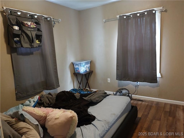 203 3rd St, Stover, MO 65078 - bedroom featuring wood finished floors and baseboards