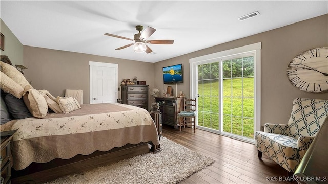 660 Upper Prairie Hollow Rd, Macks Creek, MO 65786 - bedroom featuring access to exterior, wood-type flooring, and a ceiling fan