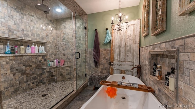 660 Upper Prairie Hollow Rd, Macks Creek, MO 65786 - full bath featuring tile walls, a shower stall, a freestanding tub, a chandelier, and a wainscoted wall