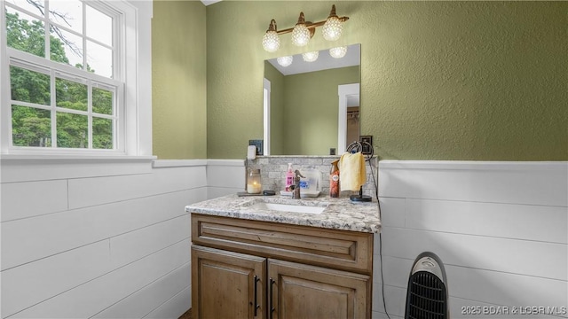 660 Upper Prairie Hollow Rd, Macks Creek, MO 65786 - bathroom with wainscoting, vanity, and a textured wall