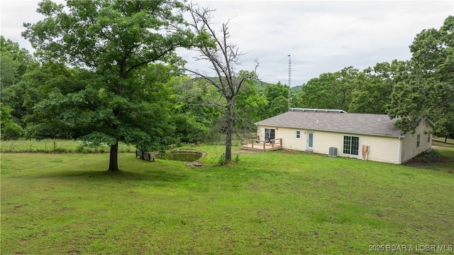 660 Upper Prairie Hollow Rd, Macks Creek, MO 65786 - view of green lawn with a deck and central air condition unit